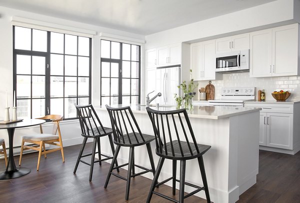 Dining area featuring modern furnishings and pendant lighting in The Madelon Apartments, luxury living in a stylish setting