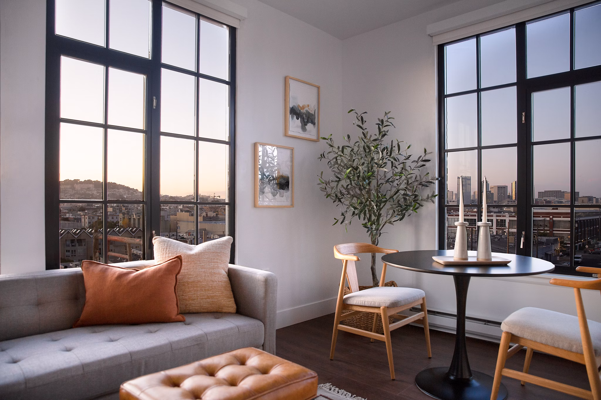 Dining area with elegant light fixtures and modern furniture at The Madelon Apartments