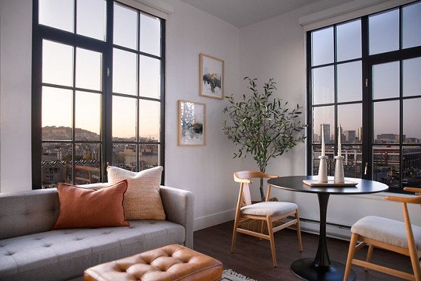 Dining area with elegant light fixtures and modern furniture at The Madelon Apartments