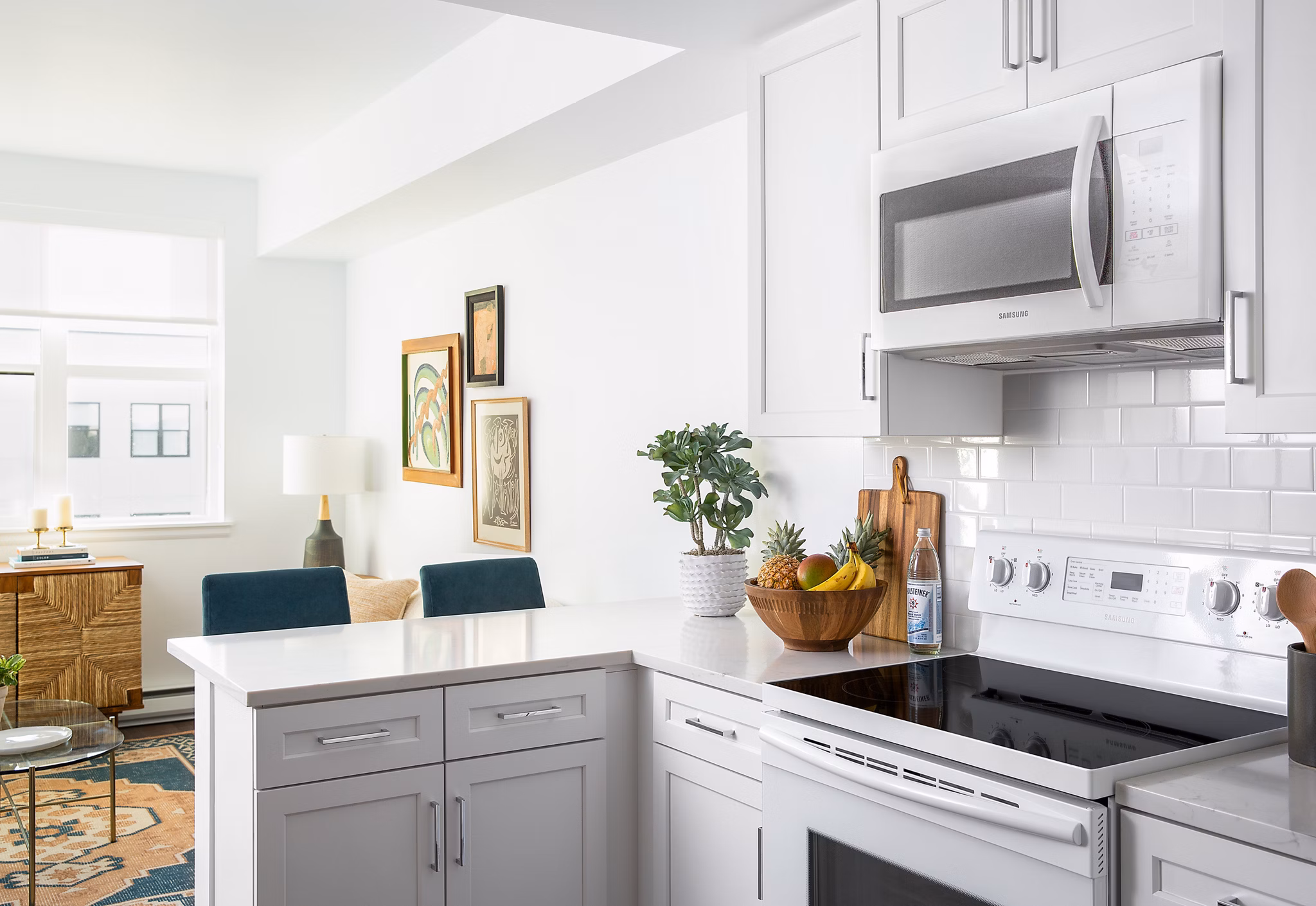 Modern kitchen with stainless steel appliances and granite countertops at The Madelon Apartments