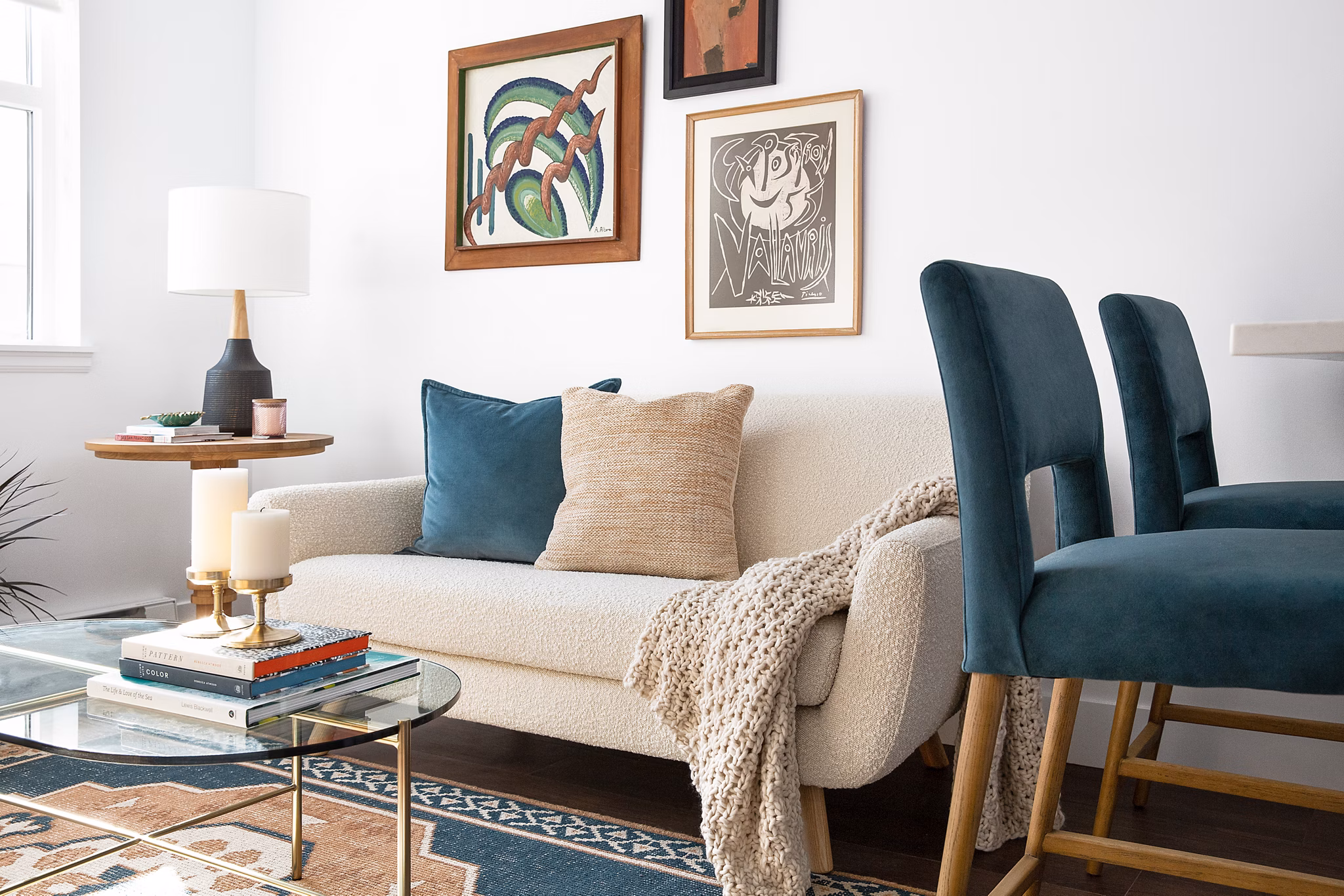 Spacious living room with modern decor and large windows at The Madelon Apartments