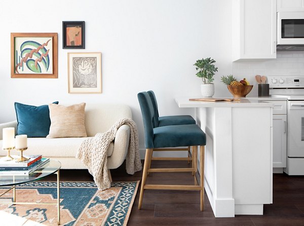 Living room with cozy seating and modern decor at The Madelon Apartments, luxury living in the heart of the city