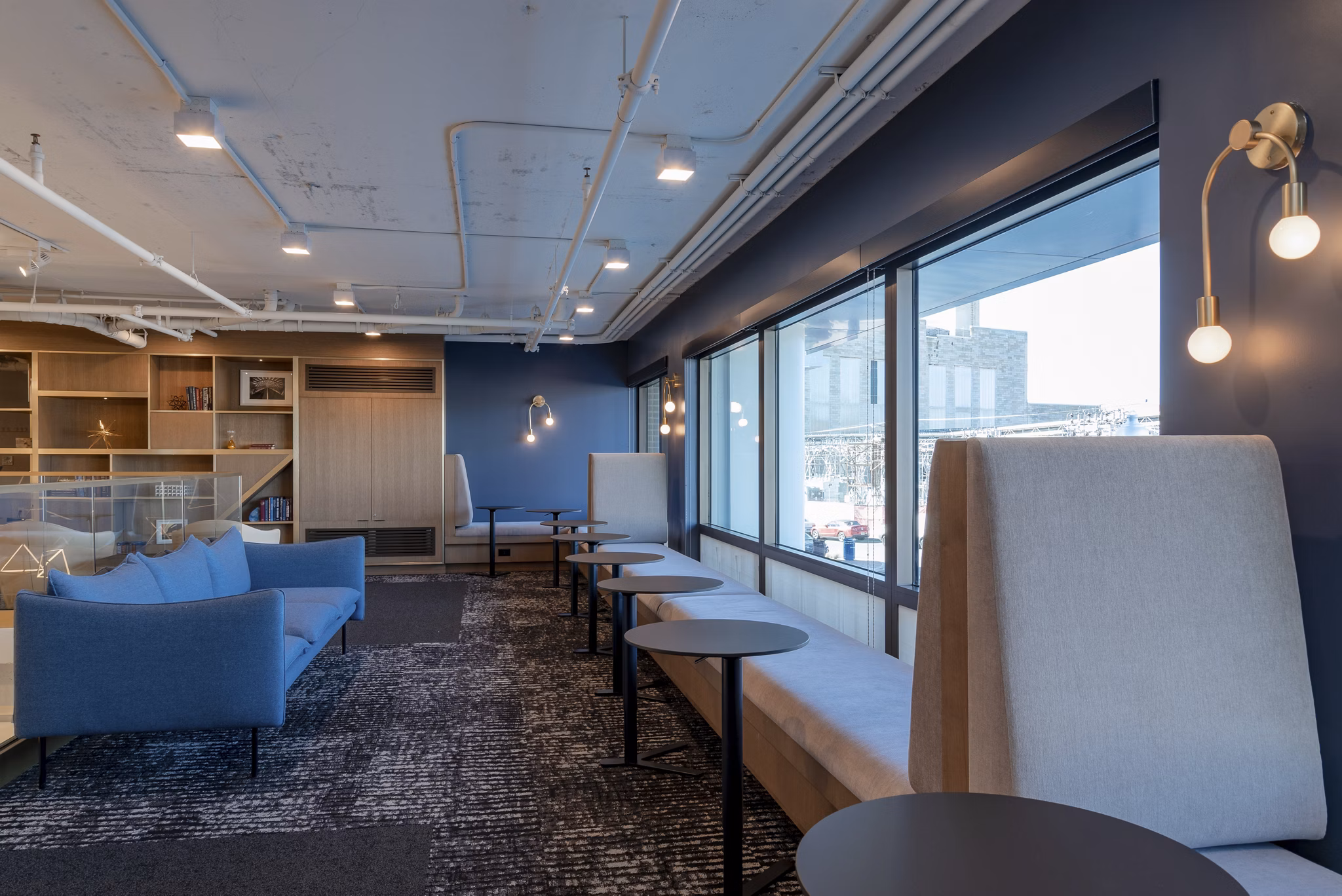 Modern lounge area with blue walls and large windows at luxury apartments