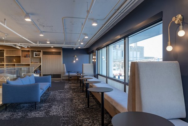 Modern lounge area with blue walls and large windows at luxury apartments