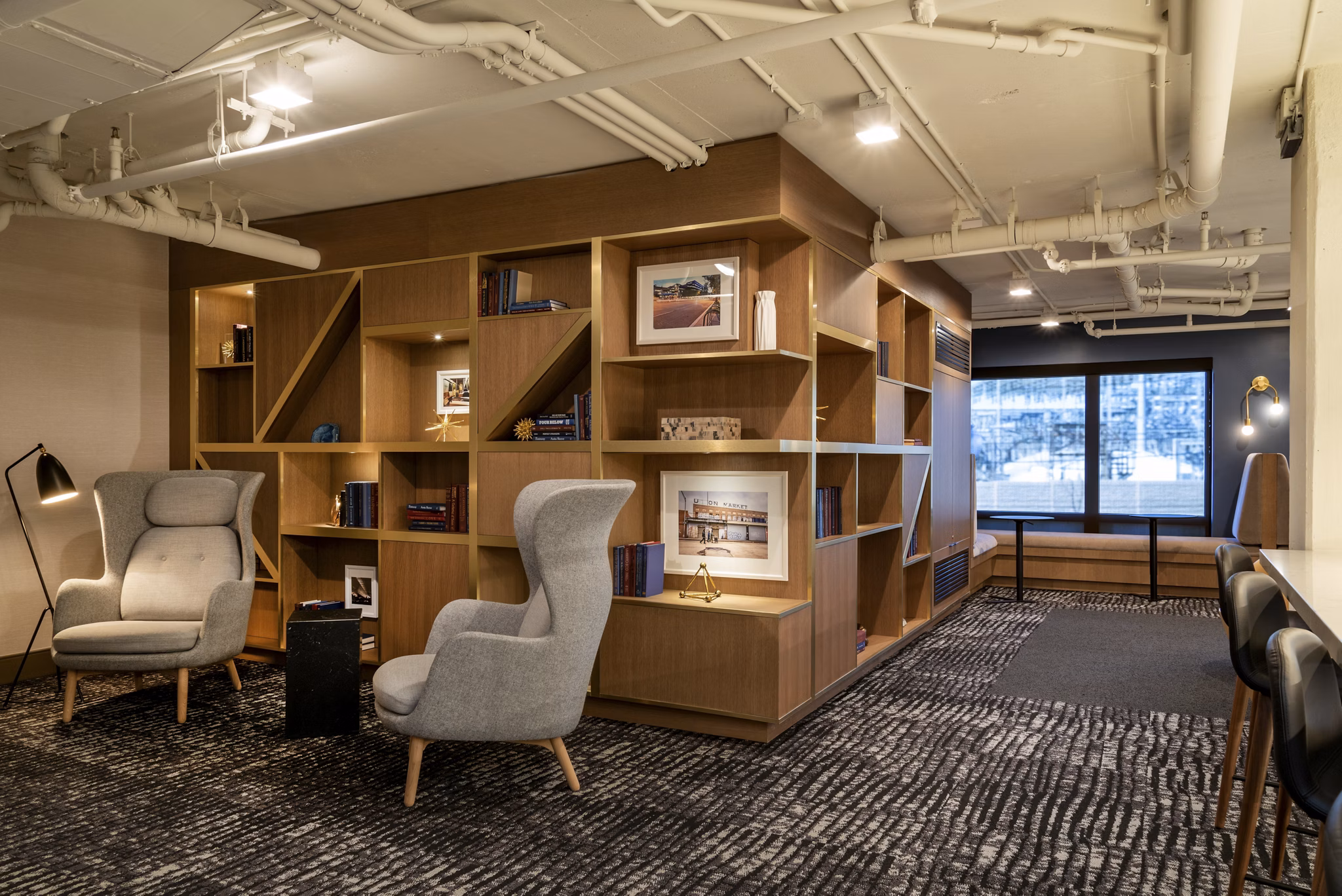 Cozy reading nook with bookshelves and armchairs in luxury apartments