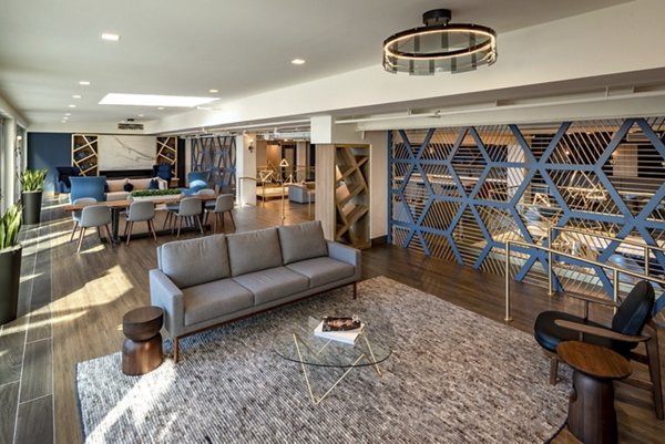 Modern living room with stylish sofa and dining area in luxury apartment