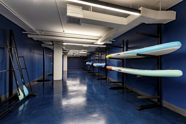 Storage area featuring paddleboards and paddles on racks in luxury apartments