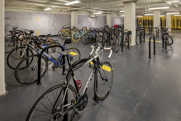 Bicycle storage area featuring secure racks for multiple bikes at luxury apartments
