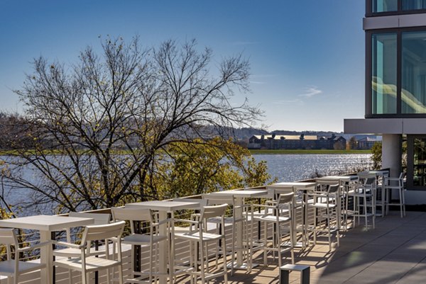 Outdoor patio area with white furniture and water views at luxury apartments