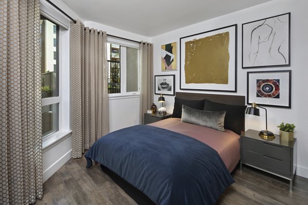 Cozy bedroom with modern decor at Lynhaven Apartments, featuring plush bedding and natural light