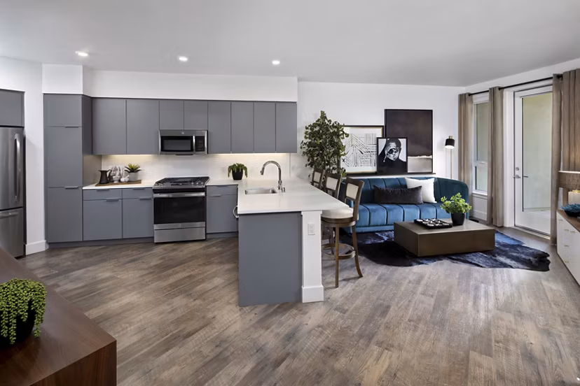 Modern kitchen with granite countertops and stainless steel appliances at Lynhaven Apartments, luxury living by Greystar