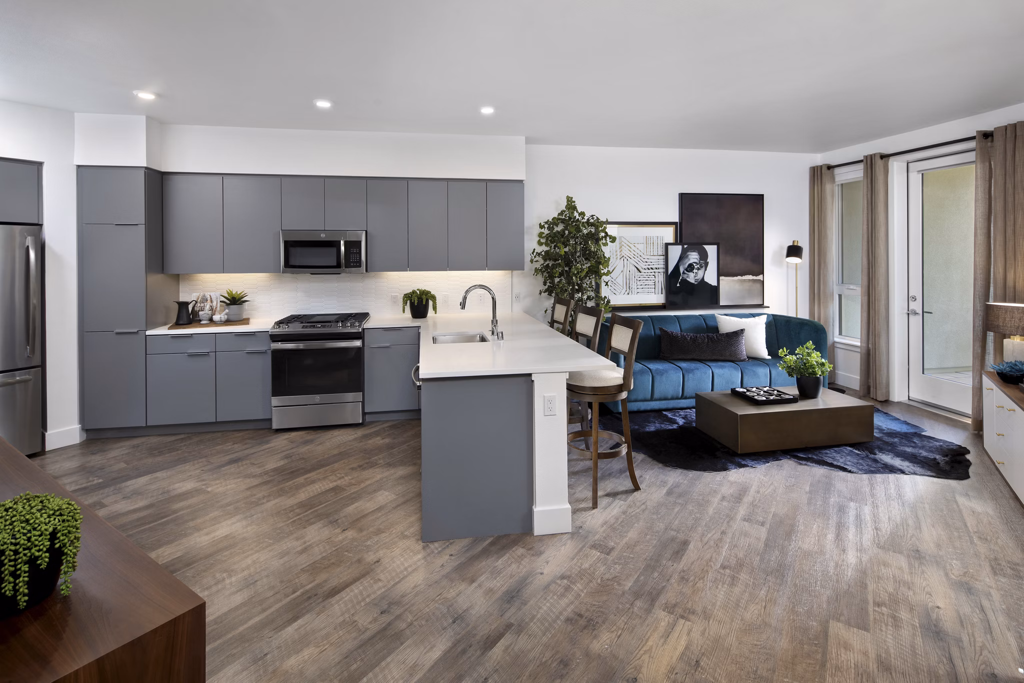 Modern kitchen with granite countertops and stainless steel appliances at Lynhaven Apartments, luxury living by Greystar
