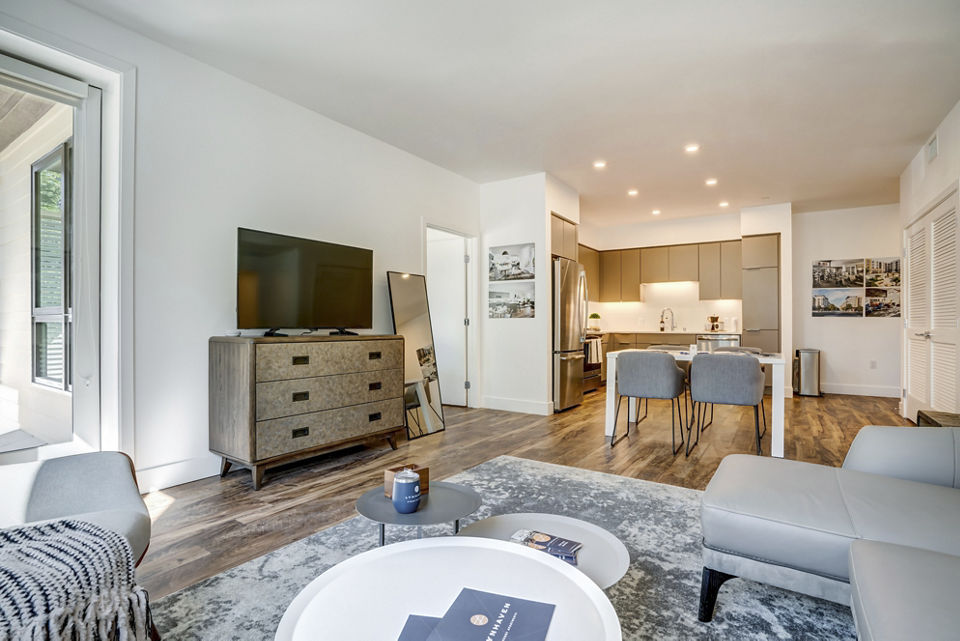 Spacious living room with modern decor at Lynhaven Apartments, featuring elegant furnishings and natural light