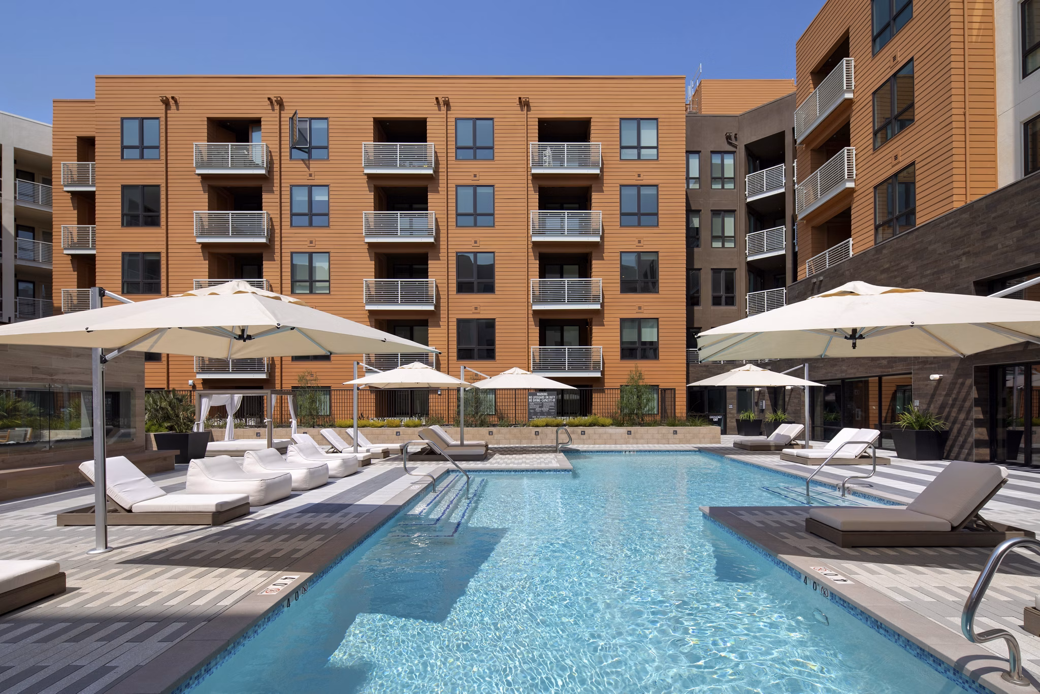 Resort-style pool with lounge chairs at Lynhaven Apartments offering luxury living experiences