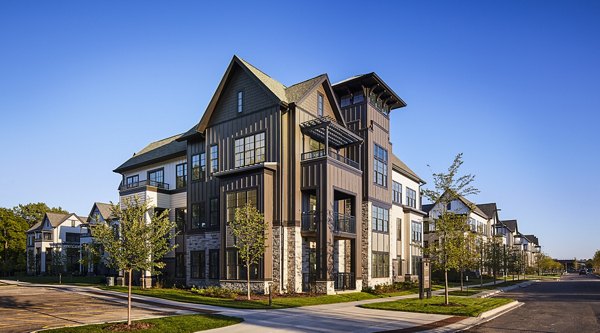 The Atworth at Mellody Farms: Luxury apartment exteriors with landscaped gardens in vibrant neighborhood