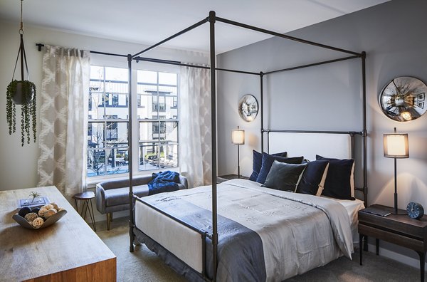 Cozy bedroom with modern decor at The Atworth at Mellody Farms Apartments