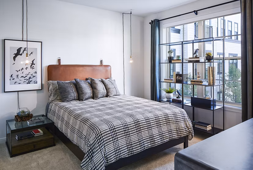 Luxurious bedroom with modern furnishings at The Atworth at Mellody Farms Apartments