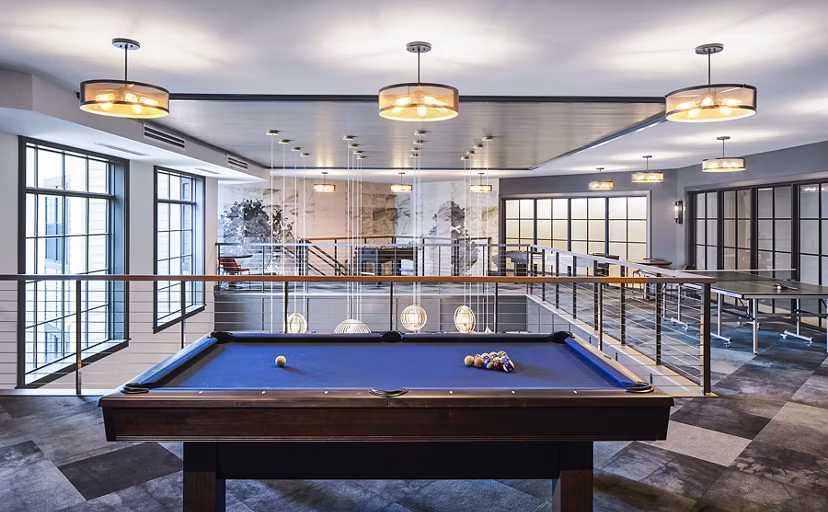 Clubhouse with modern furnishings at The Atworth at Mellody Farms Apartments featuring social and recreational spaces