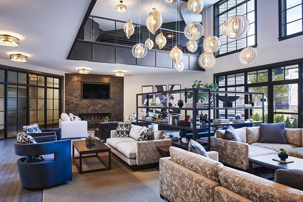 Clubhouse featuring modern decor and cozy seating at The Atworth at Mellody Farms Apartments