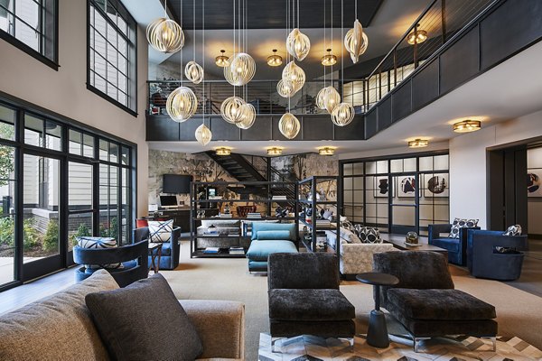 Clubhouse featuring modern decor and seating at The Atworth at Mellody Farms Apartments in Greystar's luxury community