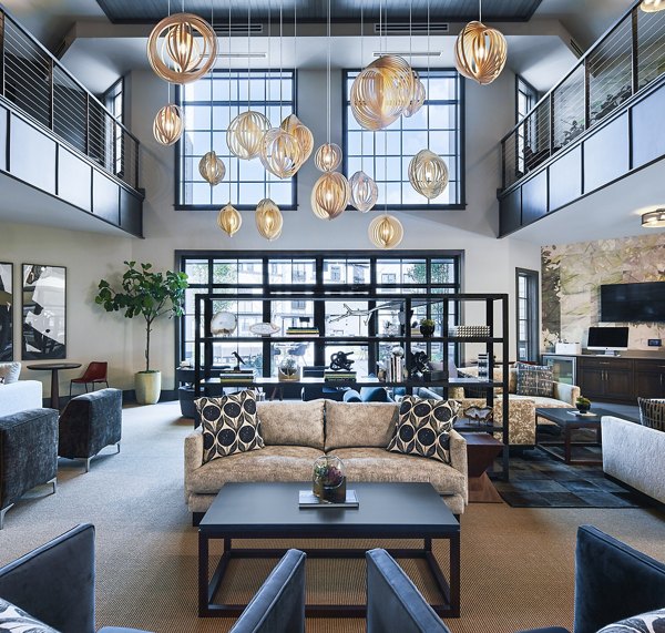 Clubhouse featuring modern design and cozy seating at The Atworth at Mellody Farms Apartments