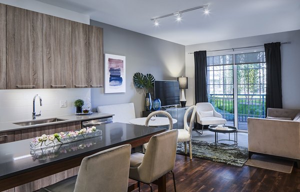 Dining area with modern fixtures and elegant table setting at The Atworth at Mellody Farms Apartments