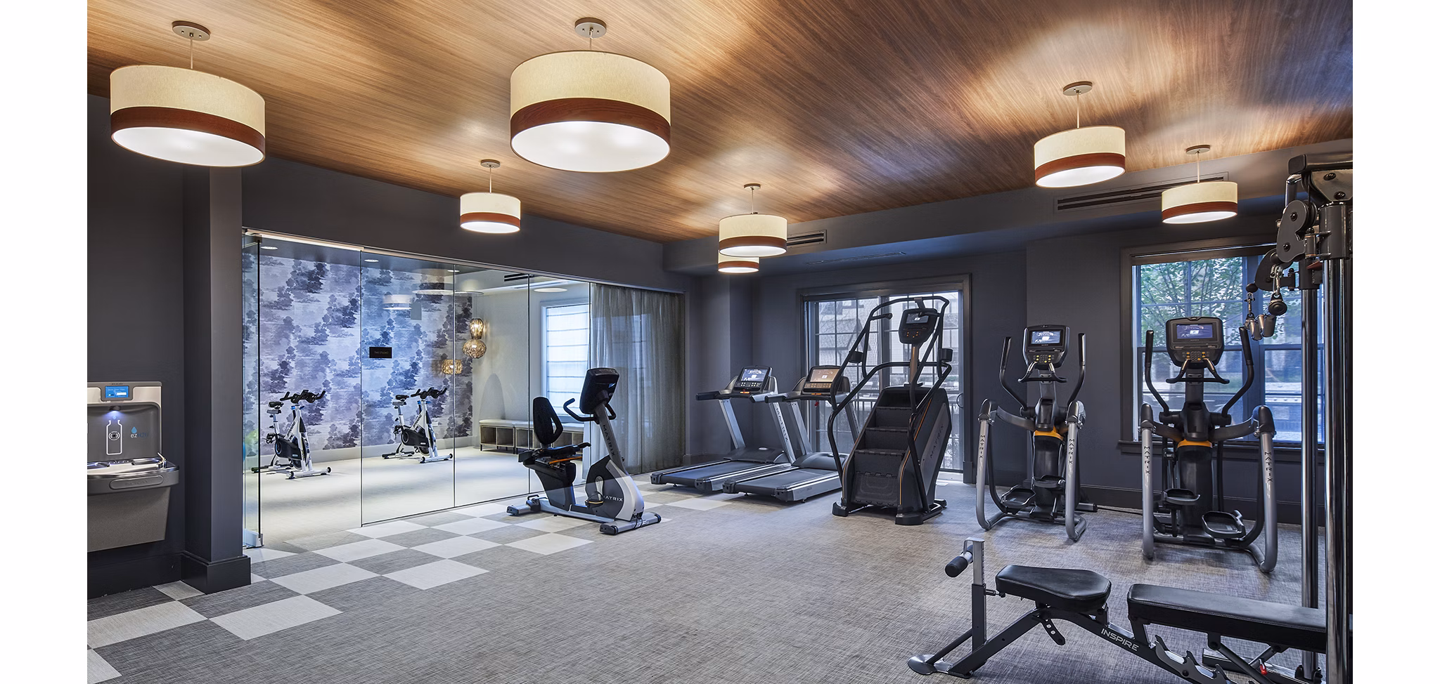 Modern fitness center with state-of-the-art equipment at The Atworth at Mellody Farms Apartments, offering a luxurious workout experience