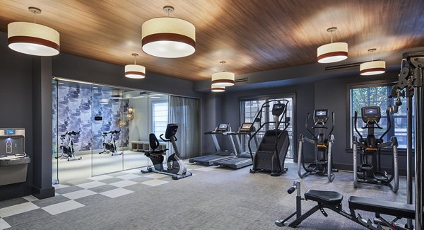 Modern fitness center with state-of-the-art equipment at The Atworth at Mellody Farms Apartments, offering a luxurious workout experience