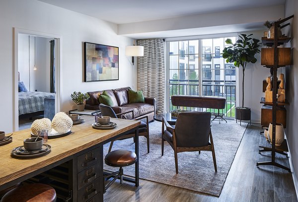 Spacious living room with modern furnishings at The Atworth at Mellody Farms Apartments, offering luxury and comfort
