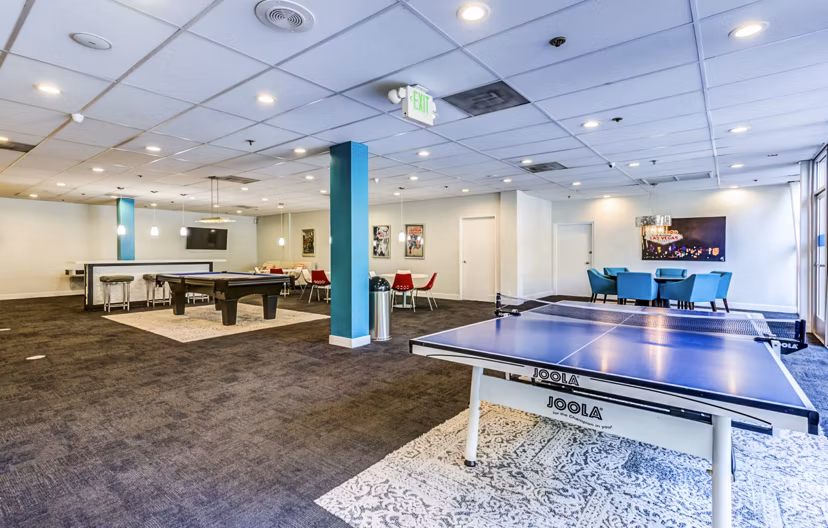 Clubhouse game room with billiards and modern seating at The Chadwick Apartments, a luxury living community by Greystar