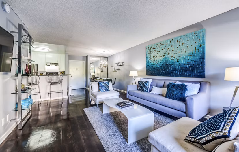 Spacious living room with modern decor and natural light at The Chadwick Apartments in Los Angeles