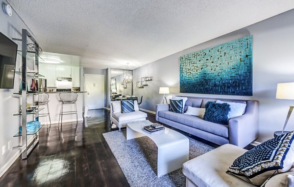 Spacious living room with modern decor and natural light at The Chadwick Apartments in Los Angeles