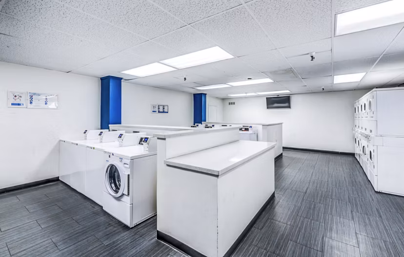 Efficient laundry facility at The Chadwick Apartments with modern appliances for resident convenience