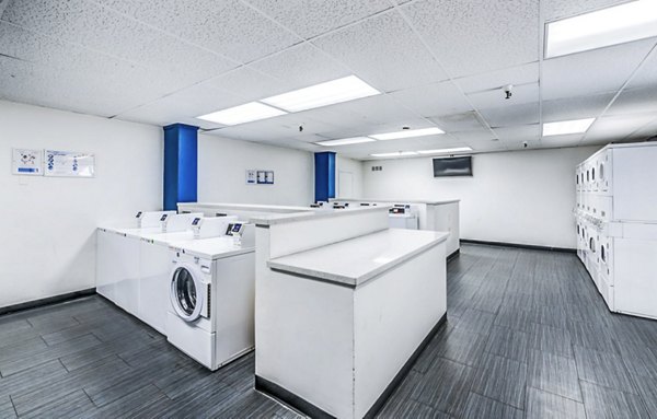 Efficient laundry facility at The Chadwick Apartments with modern appliances for resident convenience