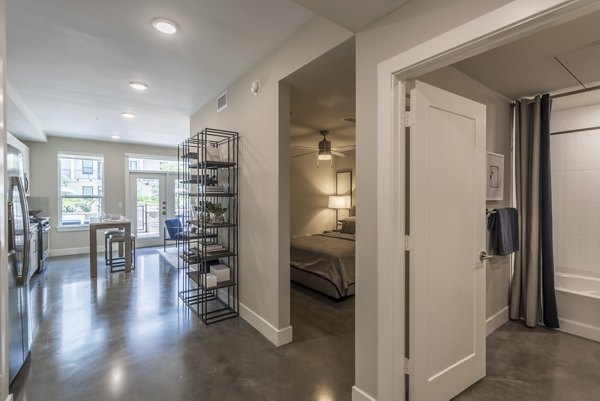 Interior view of Eighteen25 Downtown Apartments showcasing modern kitchen with stainless steel appliances and granite countertops