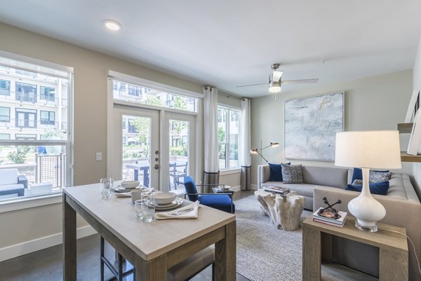 Cozy living room with modern decor in Eighteen25 Downtown Apartments, featuring a comfortable seating area and vibrant artwork