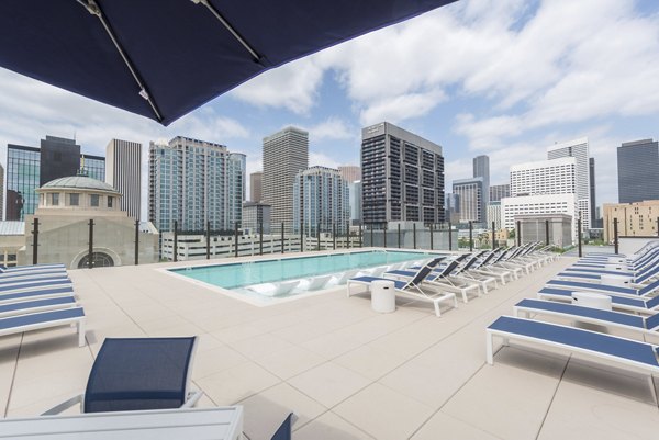 Stunning pool with lounge chairs at Eighteen25 Downtown Apartments, offering luxury relaxation in an upscale environment