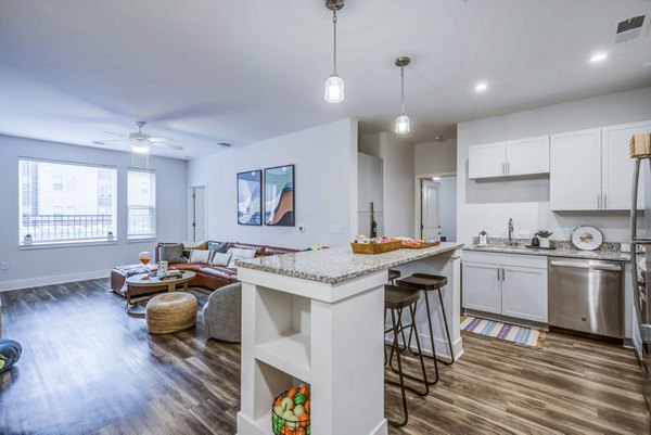 Modern kitchen with stainless steel appliances and granite countertops at Union Blacksburg Apartments