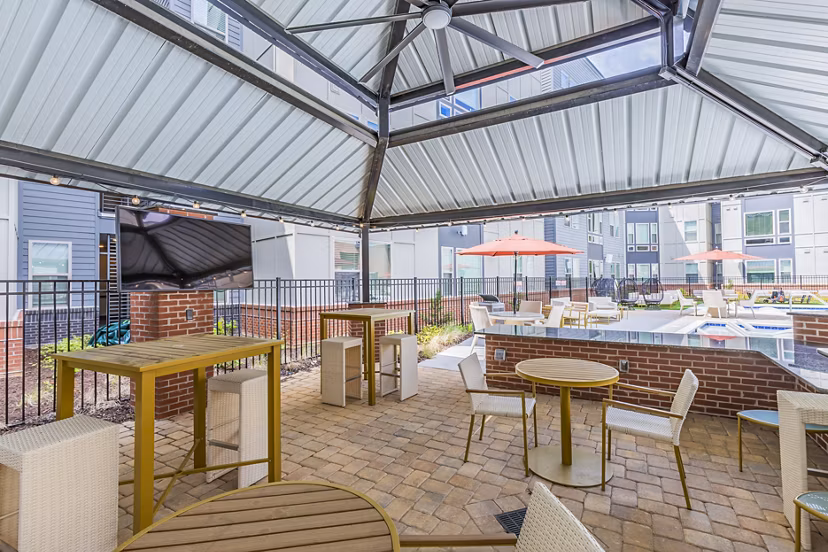 Outdoor patio with BBQ grill area at Union Blacksburg Apartments