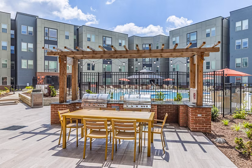 Outdoor grill area with cozy seating at Union Blacksburg Apartments, perfect for social gatherings and relaxing evenings