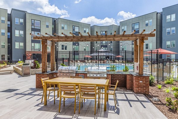 Outdoor grill area with cozy seating at Union Blacksburg Apartments, perfect for social gatherings and relaxing evenings