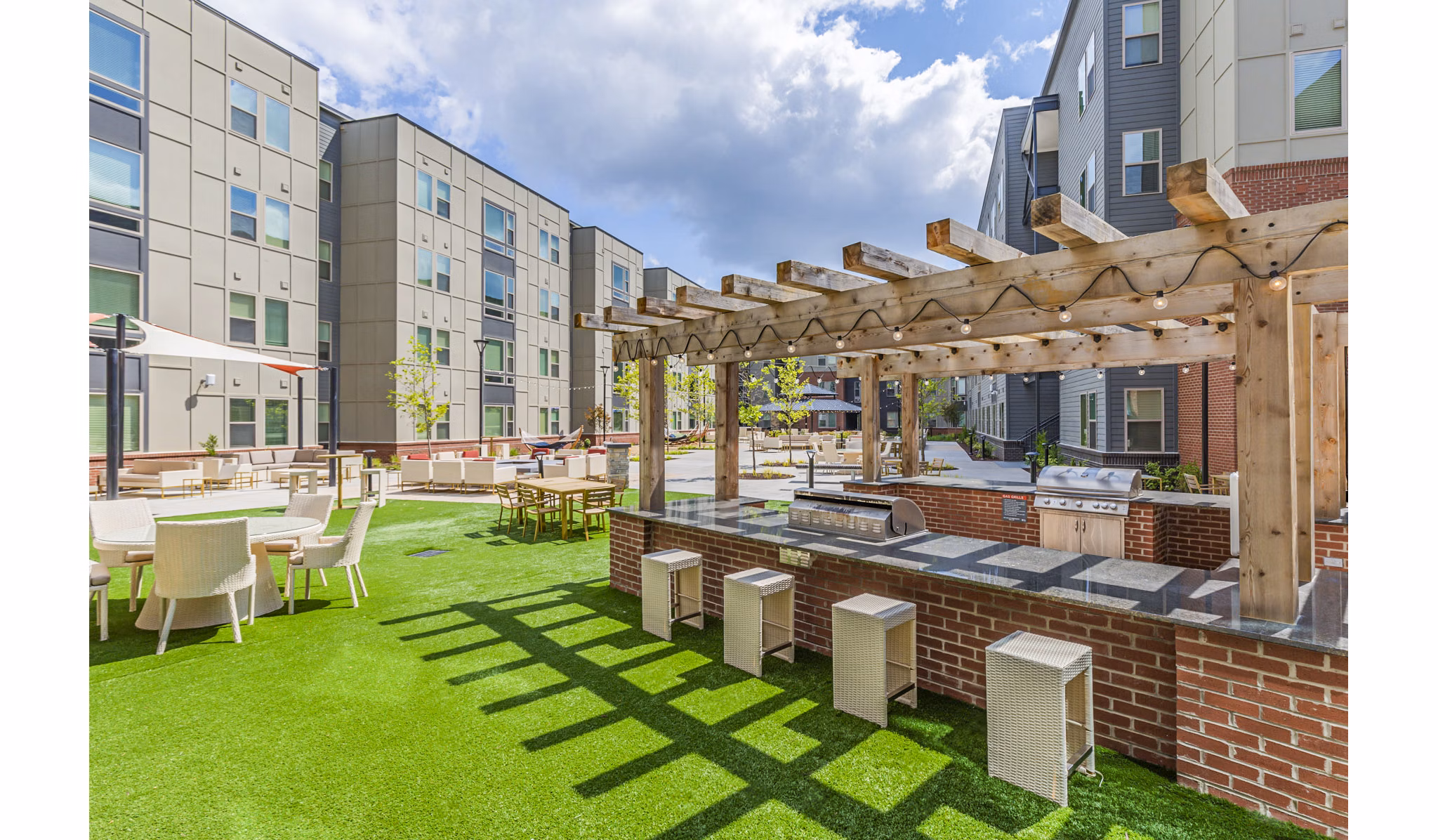 Grill area with outdoor seating at Union Blacksburg Apartments patio, perfect for social gatherings