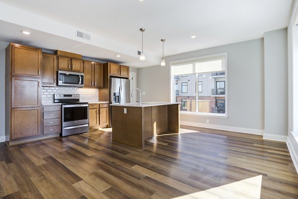Modern kitchen with stainless steel appliances in Overlook at River Place Apartments