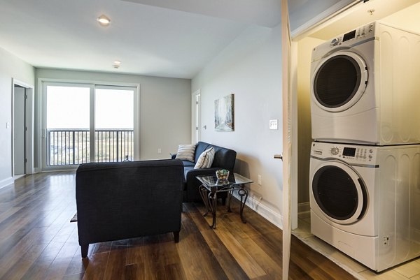 Laundry facility featuring modern appliances at Overlook at River Place Apartments