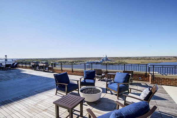 Fire pit area with cozy seating at Overlook at River Place Apartments, offering a luxurious outdoor community space