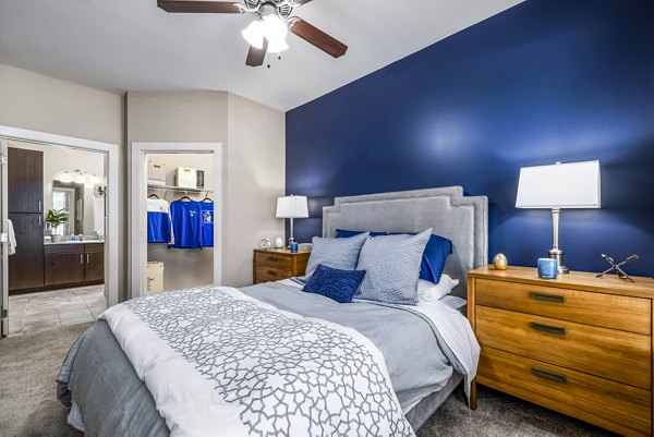 Spacious bedroom with modern decor in Whetstone Apartments, luxury Greystar property