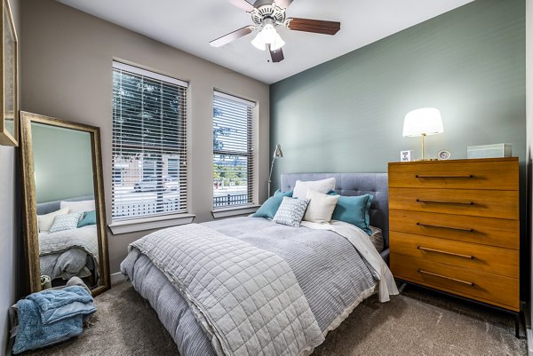 Cozy bedroom with modern furnishings at Whetstone Apartments