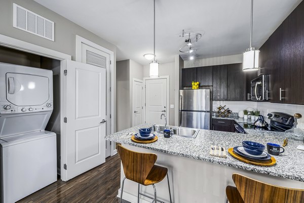 Whetstone: Modern kitchen with stainless steel appliances and laundry facilities in luxury apartment