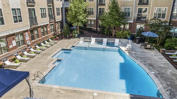 Resort-style pool with lounge chairs at Whetstone Apartments