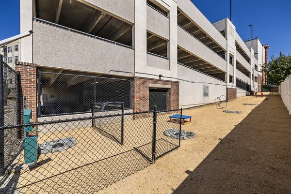 Dog park with agility equipment at Whetstone Apartments, offering fun and exercise for pets in a welcoming community setting